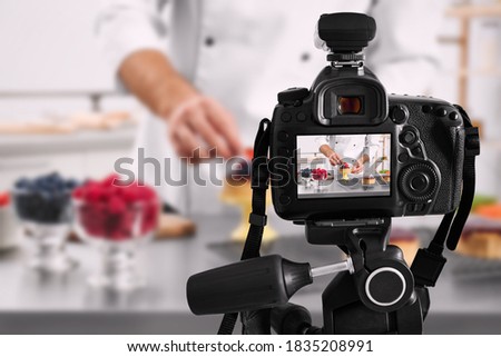 Food photography. Shooting of chef decorating dessert, focus on camera