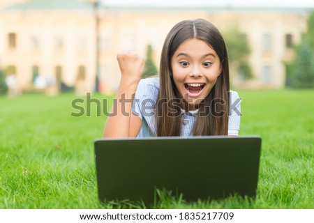 Online shop. happy blogging. girl sitting on green grass with laptop. Start up. child playing computer game. back to school. education online. knowledge day. kid learning private lesson.