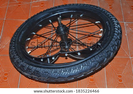 Severely damaged bicycle alloy wheel rim and over-inflated tyre.