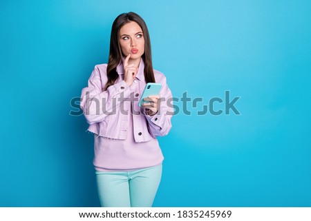 Portrait of her she nice attractive pretty lovely creative minded girl using, device gadget creating new post smm comment isolated on bright vivid shine vibrant blue color background