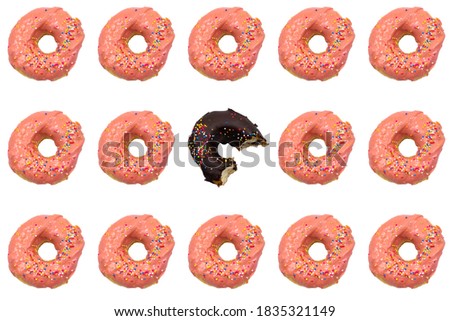 Abstract background picture of donuts Chocolate flavor with eating marks With pink sugar donuts placed around.