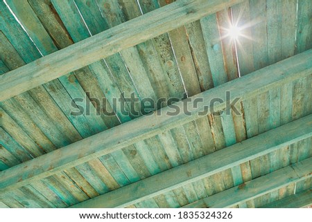 Roof wooden structure on construction site. Installation of wooden beams which are processed with mold and mildew disinfectants