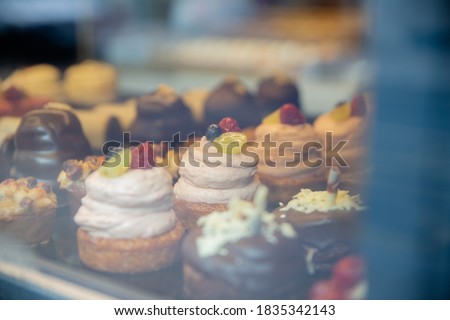 Picture of Chocolate and Cream Muffins and Cupcakes Through the glass of a Window from a bakery