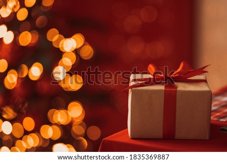 holds in his hand a box with a gift for Advent holiday.  Happy New Year and Merry Christmas