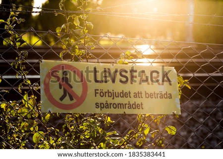 Livsfara! Danger! Keep out! Do not enter! Warning sign in sunset