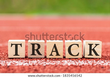 Light coloured running track background and blocks with the word track, template, concept healthy lifestyle, sports, morning run
