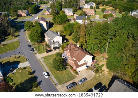 Aerial drone shot of a beautiful subdivision in suburbs taken during golden hour