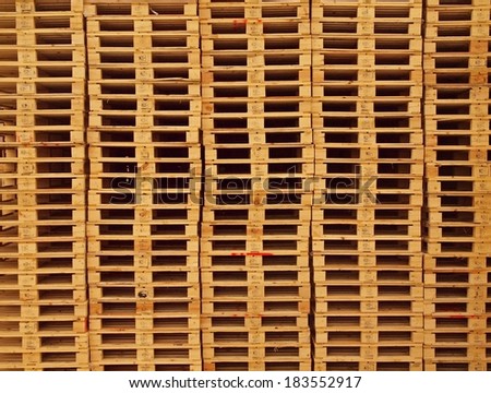 Texture of wooden euro pallets stocked in high column
