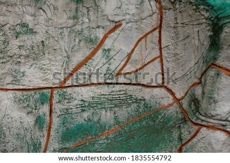 big gozinotal photo. Background. Cracks in the stone wall. Old green wall with brown cracks. Natural material. wall decoration.