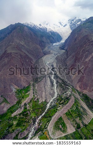 landscape photos of glaciers and valleys in hunza and nagar gilgit Baltistan , minapin glacier and rakaposhi peak in clouds
