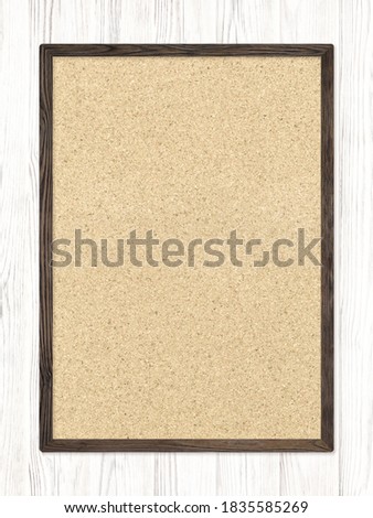 Cork board hung on a white wooden wall