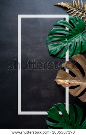 tropical green leaves and palms with white paper note frame, nature flat lay concept