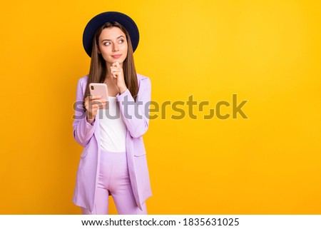 Portrait of her she nice attractive lovely elegant bewildered teen girl using cell creating, post smm media content isolated on bright vivid shine vibrant yellow color background