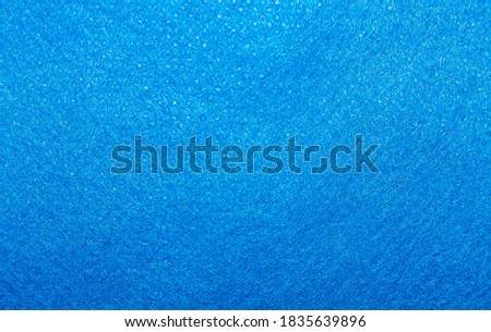 The fabric background is a bright blue color. Texture.