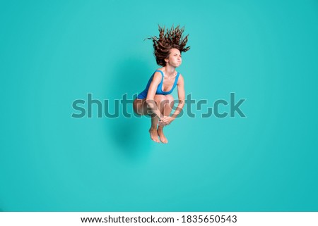 Photo of slim thin slender girl rest relax resort jump springboard dive water pool hold breath, hands legs wear blue bodysuit isolated over turquoise color background Royalty-Free Stock Photo #1835650543
