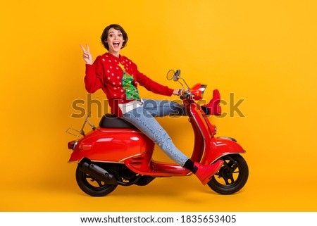 Full length profile side photo oexcited girl ride scooter x-mas noel eve tradition, theme party make v-sign wear christmas tree decor sweater pullover isolated bright shine color background