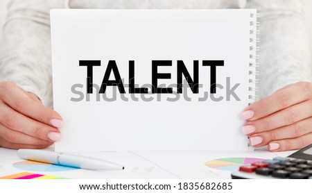 businessman holding a card with text TALENT
