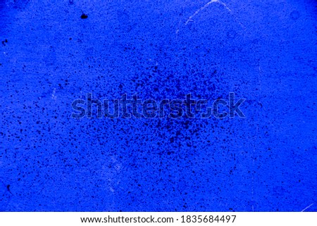 Blue colored wall texture background with textures of different shades of blue and dotted in the center