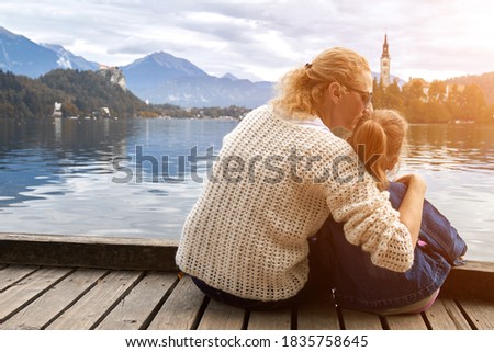 Mother and daughter having a good time on a lake.