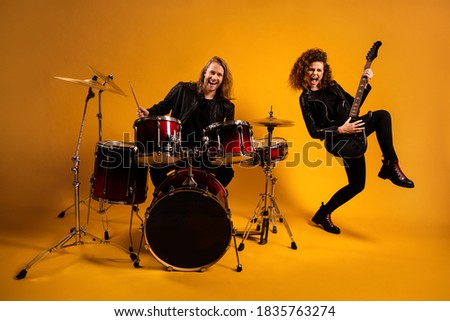 His he her she nice attractive cheerful cheery glad cool couple playing, music bass rhythm sound dream job worker profession isolated on bright vivid shine vibrant yellow color background