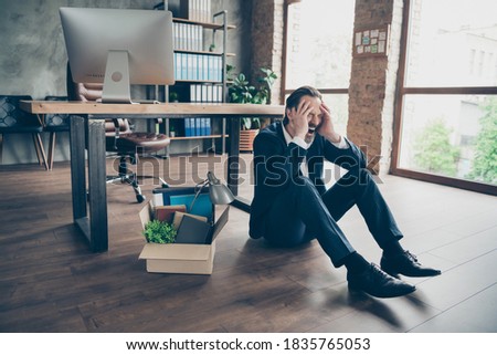 Photo of laid off dismissed sad worker mature guy fail fired agent lost job packed belongings, box financial crisis sit floor wooden parquet hopeless cry yell workstation office indoors Royalty-Free Stock Photo #1835765053