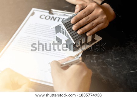 Real Estate concept. A man is signing a real estate lease.