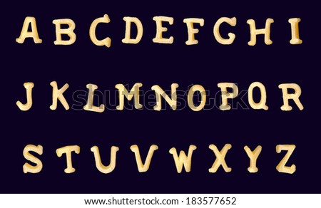 Funny yellow latin alphabet from cereals products isolated on a black background. Appetizing collection of decorative characters and symbols Royalty-Free Stock Photo #183577652