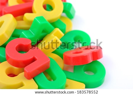 Colorful plastic numbers on white background