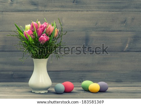 tulip flowers with easter eggs. vintage decoration. retro style toned picture