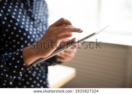 Cropped close up view female hands using tablet wireless portable gadget. Concept of remote communication to client, buyer of online goods and services, telecommute distance freelance work from home
