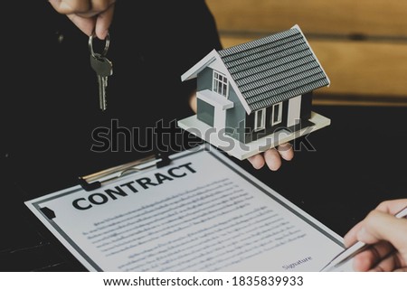 The lessor is handing over the keys to the tenant. Concept of purchasing new apartment.