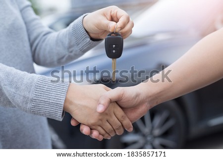 A picture of a buyer, a morning person or a seller delivering the car key.