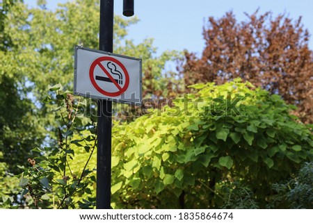 Sign in a public place informing that smoking is prohibited. Blurred background