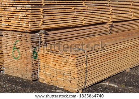 Wood planks for sale. Stacks of processed wood at the timber yard. Background
