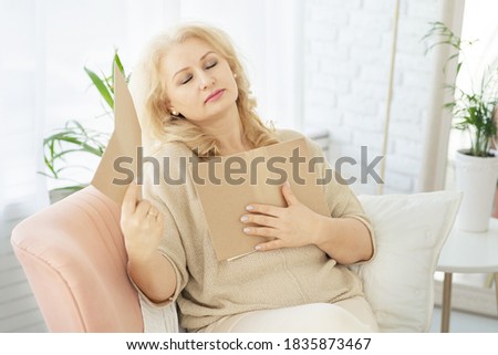 A middle-aged woman woman feels bad because of menopause. She needs support. Hot flashes, sweating, dizziness, irritability. Menopause concept. Harmonious restructuring of the body. Royalty-Free Stock Photo #1835873467