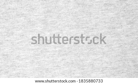 Close up gray cotton heather texture background.  
Black and white textured knit fabric pattern seamless.
Selective focus.
top view. Royalty-Free Stock Photo #1835880733