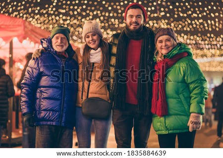 Portrait of nice attractive cheerful family meeting embracing traveling, spending time visiting festal street market newyear gathering tradition wintertime outside outdoor