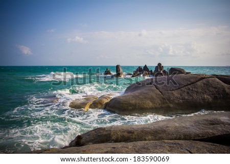 Stones in a sea and blue sky, water background