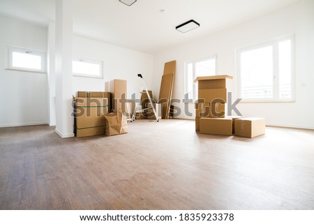 Empty Room With Moving Boxes Or Cartons Royalty-Free Stock Photo #1835923378