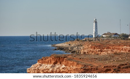 beautiful tall white lighthouse at sunset Crimean peninsula Cape Fiolent