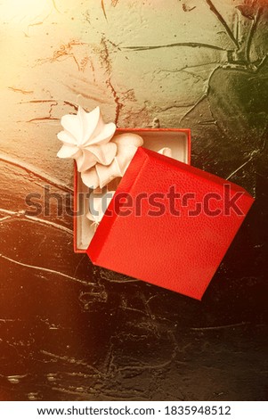 An original gift. Gift red meringue box.Party background. Template for posters and banners Flat lay photo with copy space