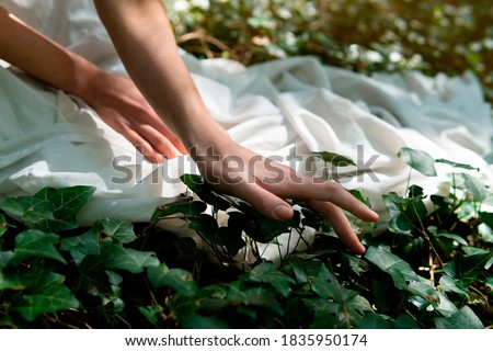  A woman in a white dress in the middle of the forest Royalty-Free Stock Photo #1835950174