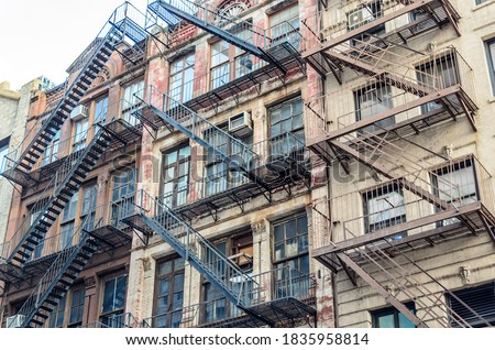 Low Angle View of Typical Apartment Buildings with Fire Escape Ladders in Manhattan,  New York City, USA