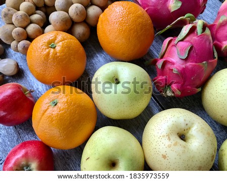 Colorful and fresh organic mixed fruits group on the wooden background
