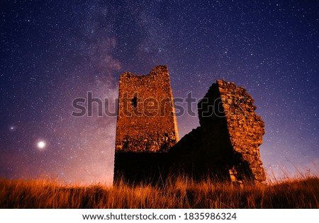 a castle with they milky way in the background