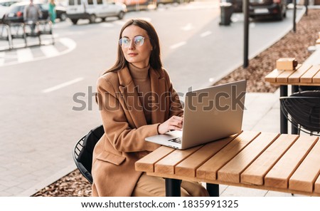 Successful businessman working at laptop. Business woman working. Sales woman working using her laptop while writing text. Businesswoman in glasses working on-line. Mobile technology.