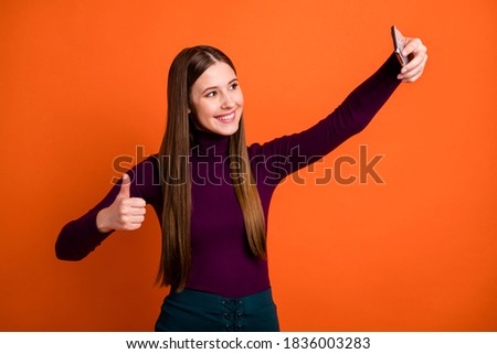Photo of positive cheerful girl travel trip make selfie smartphone, show thumb-up sign wear purple violet jumper isolated over bright shine color background