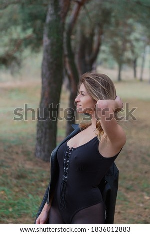 Beautiful woman posing in autumn forest. Beautiful pictures of women.