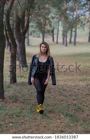 Beautiful woman posing in autumn forest. Beautiful pictures of women.