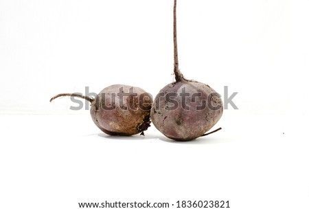 Still life - vegetables from the garden, dark red beets on a white background.